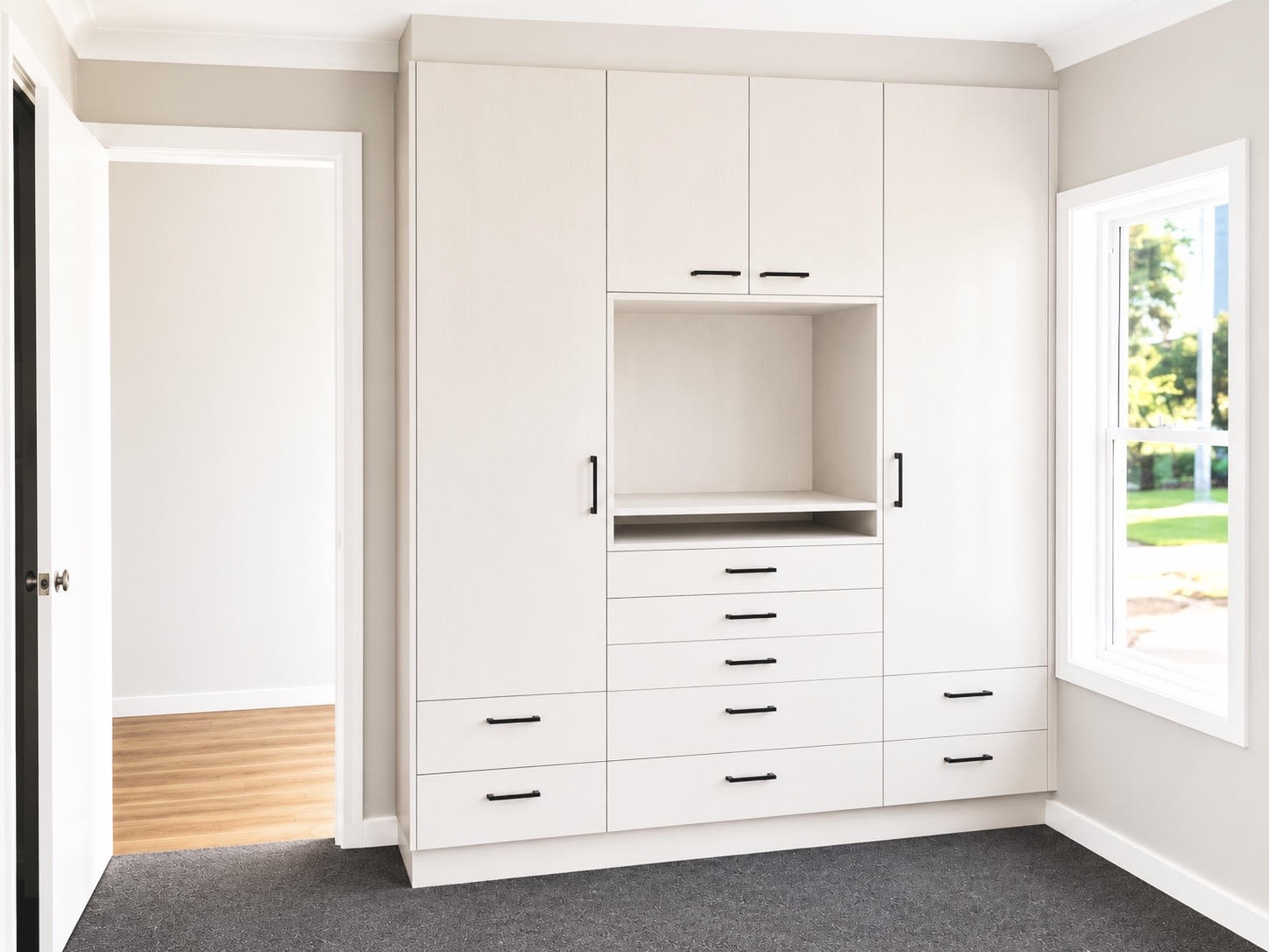 Built-in wardrobe with open shelving nook and drawer bank